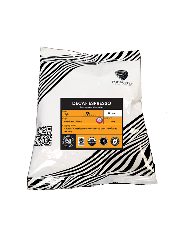 A 2oz ground bag of Fogbuster® Coffee Works Decaf Espresso, with a black and white striped design; this light Honduras Timor espresso offers cocoa tasting notes.