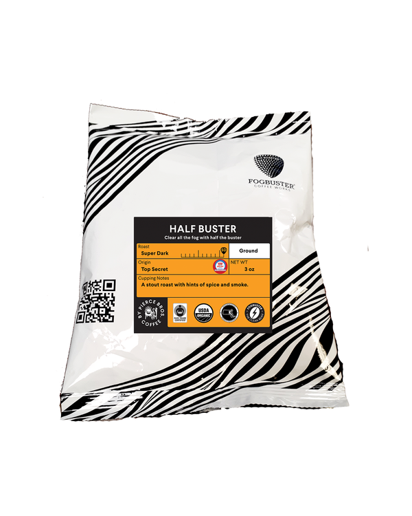 A 1 oz ground coffee bag from Fogbuster® Coffee Works, “Half Buster” is a super dark roast that’s half decaf, offering robust spice and smoke notes for a bold cup.