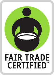 The Fair Trade Certified logo features a stylized human figure holding a bowl, designed in black against a green circular background, with the text "FAIR TRADE CERTIFIED" below the icon. The image is surrounded by a white rectangular border.