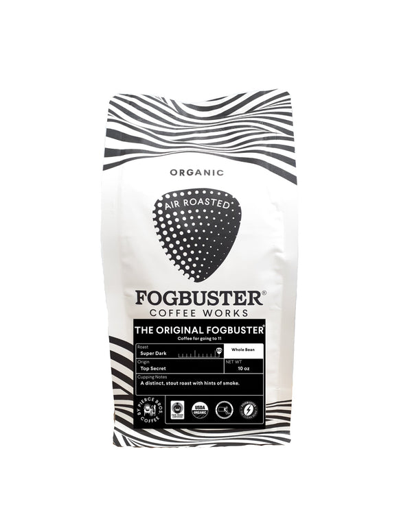 A white bag of Fogbuster® Coffee Works The Original FogbusterⓇ features a black and white striped design, organic and air-roasted labels, stout roast details, and cupping notes highlighting its bold dark roast flavor.