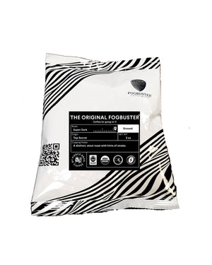 A white and black striped 3oz coffee bag labeled "The Original FogbusterⓇ Sample" from Fogbuster® Coffee Works, features stout super dark roast ground coffee with rich, smoky flavor notes.
