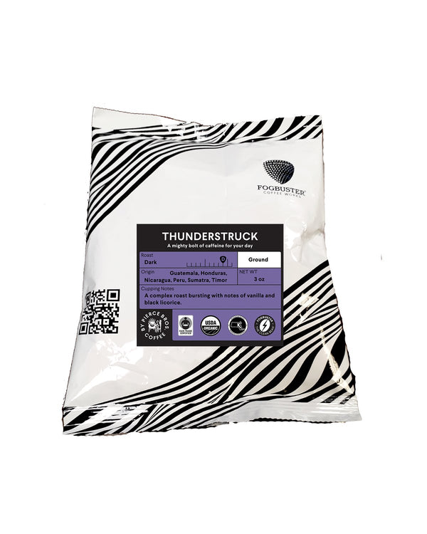 The "Thunderstruck" French roast coffee from Fogbuster® Coffee Works, featuring a design with white and black stripes, presents a premium shade-grown dark roast blend originating from Guatemala and Honduras. It offers flavor notes of vanilla and black licorice for a bold caffeine experience. Additionally, it includes a handy QR code.